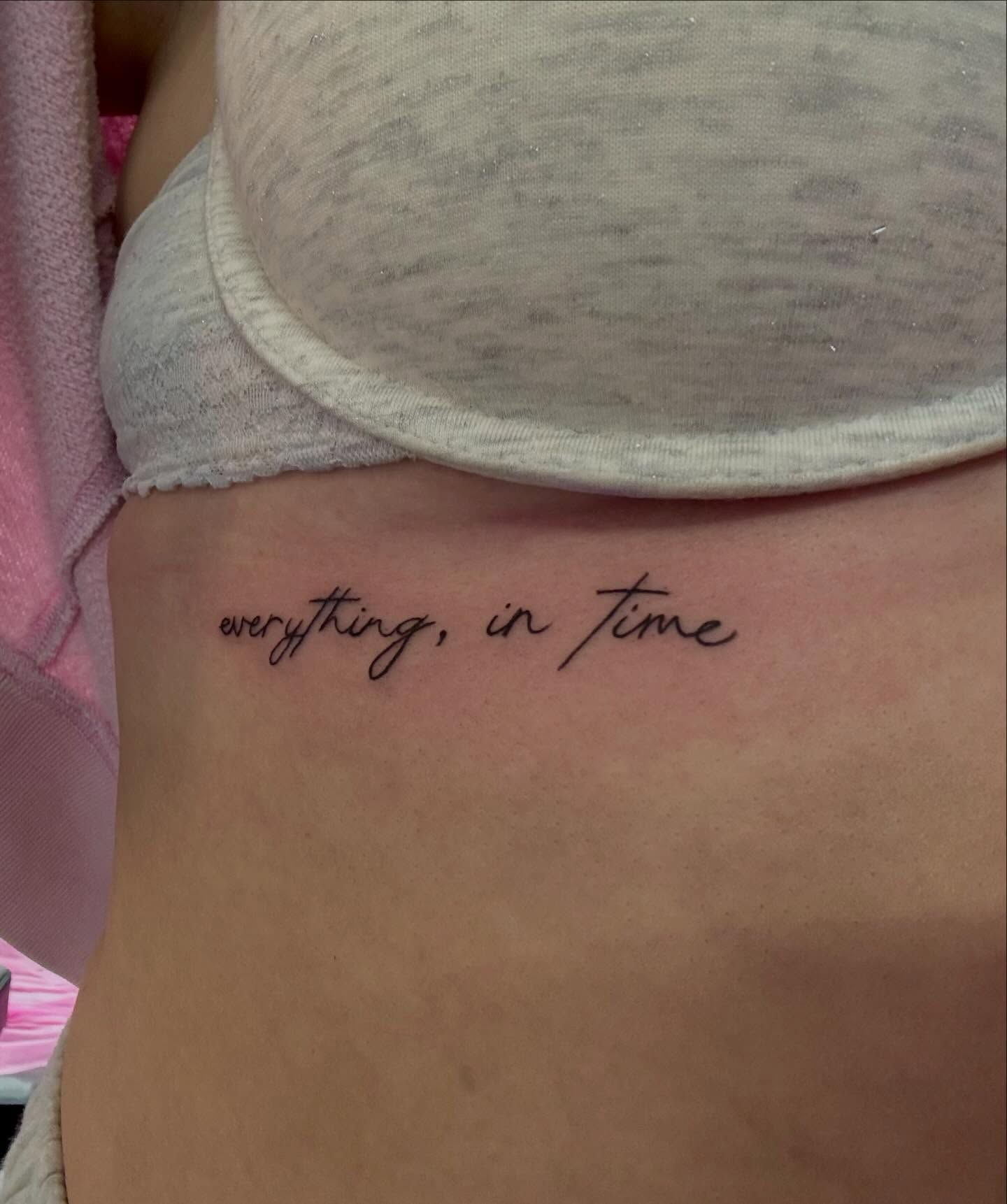The words "everything, in time" in fine-line handwritten script across the ribs